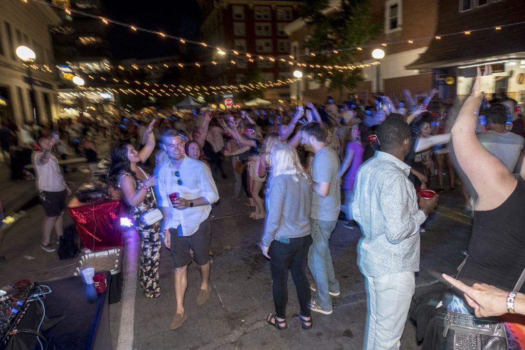 Partygoers dance during the Iowa City Downtown District Block Party on Saturday June 23, 2018. The 2nd annual event during which open containers were allowed in a select portion of downtown attracted thousands of guests and featured a variety of activities and performances. (Nick Rohlman/The Daily Iowan)