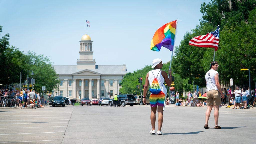 Participants of the pride parade walk towards the old capital. (Roman Slabach/The Daily Iowan)