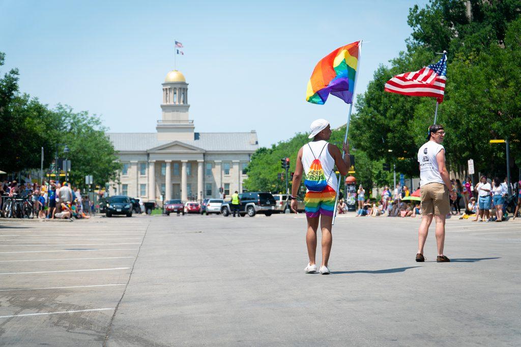 Participants in Iowa City Pride parade walk towards the old capital. 