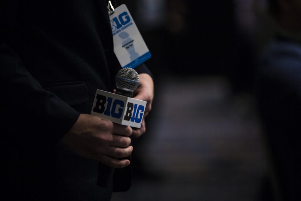 A Big Ten volunteer holds a microphone between questions during Big Ten Football Media Days in Chicago on Monday, July 23, 2018. (Nick Rohlman/The Daily Iowan)