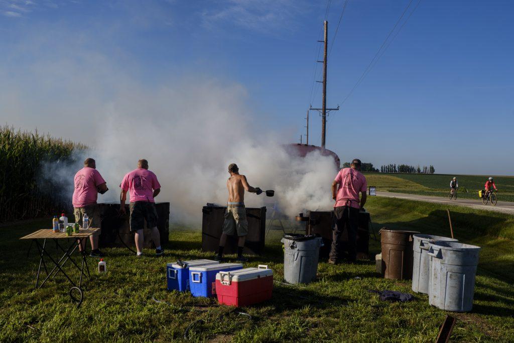 Mr. Pork Chop Employees cook pork outside of Wellman, Iowa during RAGBRAI on Friday, July 27, 2018. Riders rode from Sigourney to Iowa City on Day 6 of this years ride. (Nick Rohlman/The Daily Iowan)