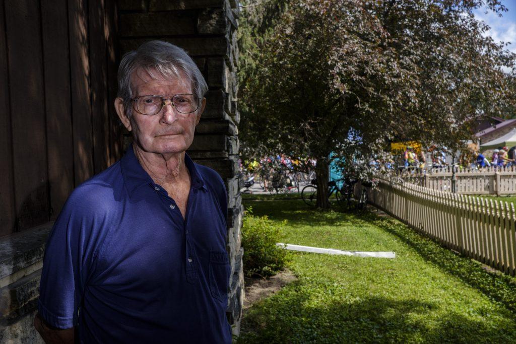 Ron Harland poses for a portrait in his yard in Kalona, Iowa during RAGBRAI on Friday, July 27, 2018. Harland has lived in Kalona for 85 years and works at a local library and had just returned home from work as the bulk of riders began to arrive in town. Riders rode from Sigourney to Iowa City on Day 6 of this years ride. (Nick Rohlman/The Daily Iowan)