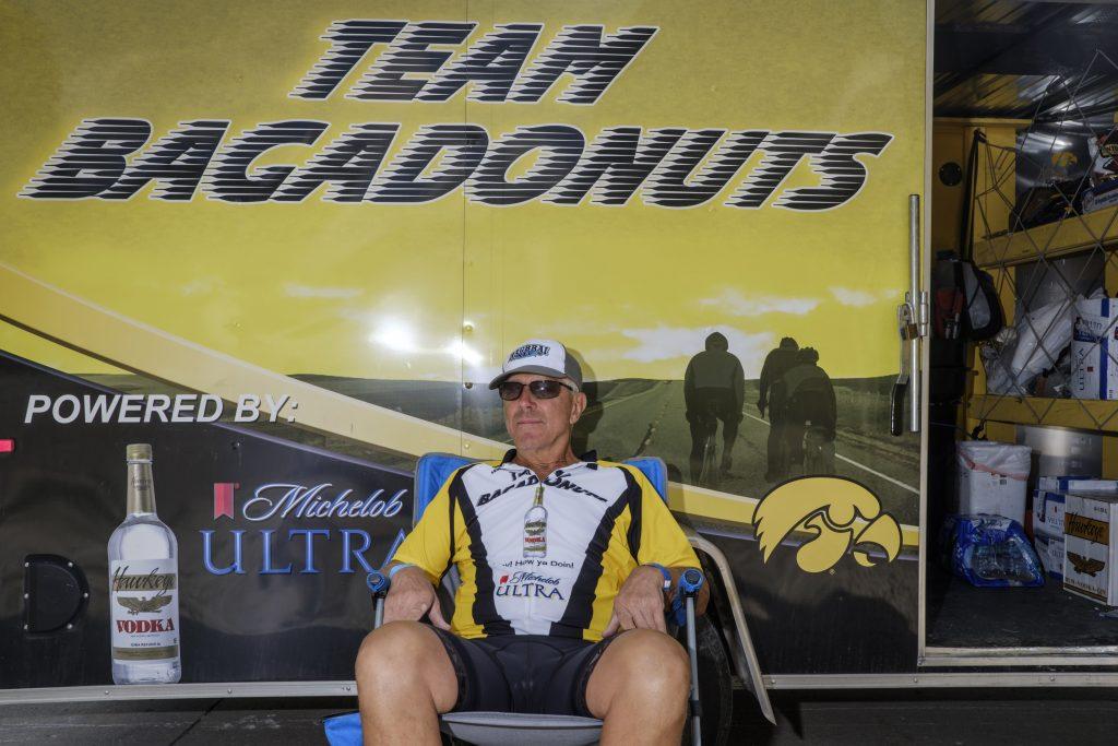 Alan Carlson of Waterloo poses for a portrait in Kalona, Iowa during RAGBRAI on Friday, July 27, 2018. Carlson was waiting for his Team Bagadonuts teammates and said that today was his turn to drive the trailer. Riders rode from Sigourney to Iowa City on Day 6 of this years ride. (Nick Rohlman/The Daily Iowan)