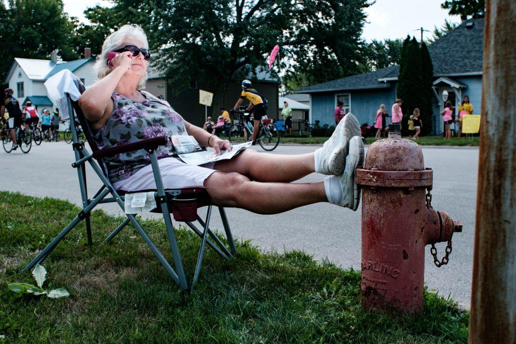 Karen Kaufmann of Spirit Lake, Iowa is seen relaxing in Kalona, Iowa while speaking to a member of her RAGBRAI team, for whom she drives the support vehicle. This is Karen and her teams 20th year riding RAGBRAI, Friday, July 27th, 2018. Riders rode from Sigourney to Iowa City on Day 6 of this years ride. (Jared Krauss/The Daily Iowan)