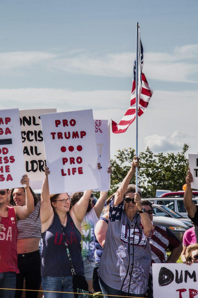 Attendees await the arrival of the president outside of Northeast Iowa Community College in Peosta on July 26, 2018. Both pro- and anti-Trump demonstrators were present at the event. (Katina Zentz/The Daily Iowan)