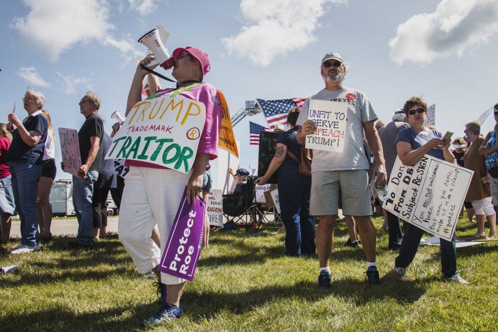 Attendees chant outside of Northeast Iowa Community College in Peosta on July 26, 2018. Both pro- and anti-Trump demonstrators were present for the arrival of the president. (Katina Zentz/The Daily Iowan)