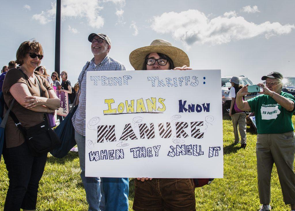 An attendee holds up a sign outside of Northeast Iowa Community College in Peosta on July 26, 2018. Both pro- and anti-Trump demonstrators were present for the arrival of the president. (Katina Zentz/The Daily Iowan)