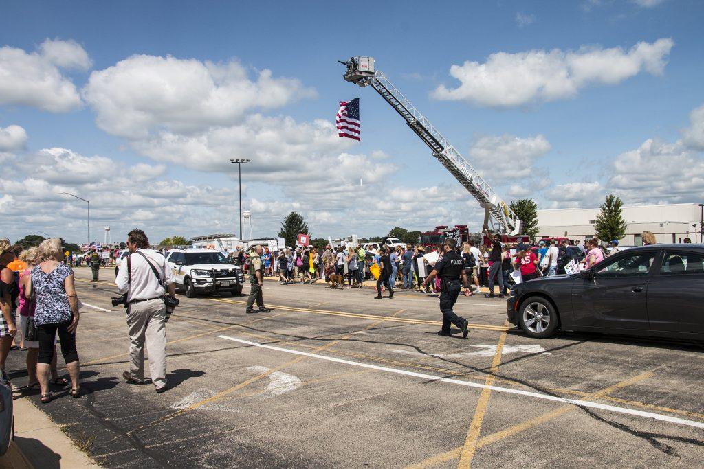 Attendees await the arrival of President Donald Trump outside of Northeast Iowa Community College in Peosta on July 26, 2018. Both pro- and anti-Trump demonstrators were present for the event. (Katina Zentz/The Daily Iowan)