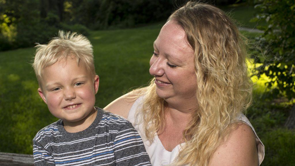 Otto Phelps and his mother Erica pose for a portrait in a park near their home on Friday, June 29, 2018. Otto was diagnosed with pre-B acute lymphoblastic leukemia in January 2017. (Nick Rohlman/The Daily Iowan)