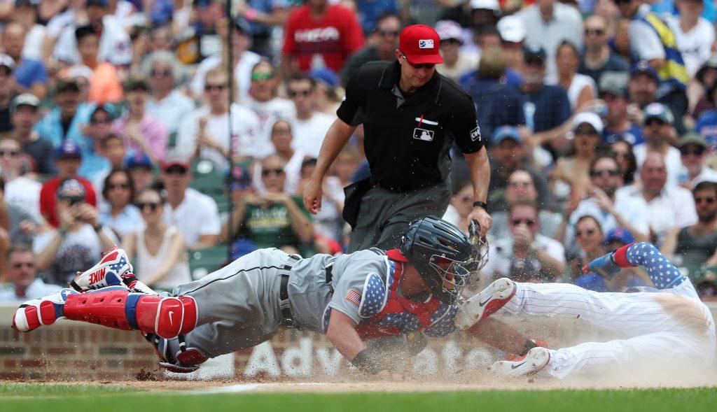 Chicago Cubs second baseman Javier Baez (9), right, steals home plate for a run as Detroit Tigers catcher James McCann (34) reaches for the late tag in the fourth inning at Wrigley Field Wednesday, July 4, 2018, in Chicago. (John J. Kim/Chicago Tribune/TNS)