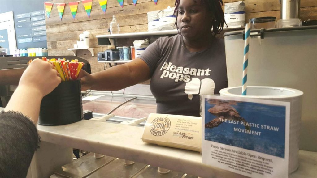 Nadia Bartholomew, a worker at Pleasant Pops coffee and treats shop in Washington, D.C., offers a customer a selection of paper straws. Pleasant Pops has joined the Last Plastic Straw movement, a growing number of restaurants no longer using plastic straws, which environmentalists say are hazardous to oceans and sea creatures. States and cities are being asked to ban straws, too. (Elaine S. Povich/Pew Charitable Trusts/TNS)