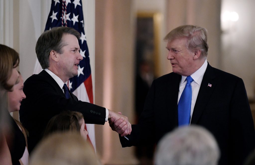 U.S. President Donald Trump shakes hands with Judge Brett Kavanaugh with after he nominated him to the Supreme Court during a ceremony in the East Room of the White House July 9, 2018 in Washington, D.C. (Olivier Douliery/Abaca Press/TNS)