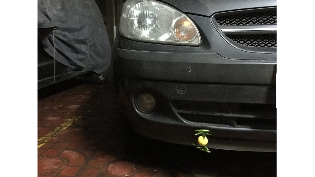 A lemon and chili pepper are tied to a car on July 16 in India. In India, it is sometimes believed that this practice wards off evil. (Aadit Tambe/The Daily Iowan)