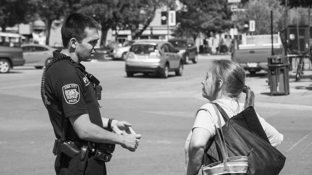 Officer Travis Graves speaks to a local citizen while on patrol downtown on Wednesday, July 25, 2018. Officer Graves is Iowa Citys new Community Outreach Officer. The Community Outreach Officer provides additional coverage of downtown prior to the Night Shift Officer. (Tate Hildyard/The Daily Iowan)