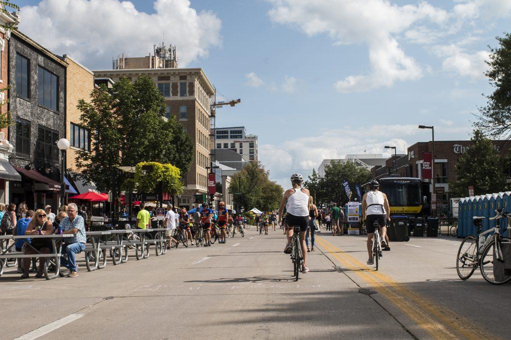 Bikers ride down the street during RAGBRAI on July 27, 2018. Riders rode from Sigourney to Iowa City on Day 6 of this year's event.