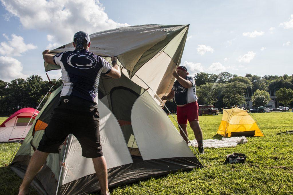 Members of the Davis family build a tent during RAGBRAI on July 27, 2018. Riders rode from Sigourney to Iowa City on Day 6 of this year's event. (Katina Zentz/The Daily Iowan)