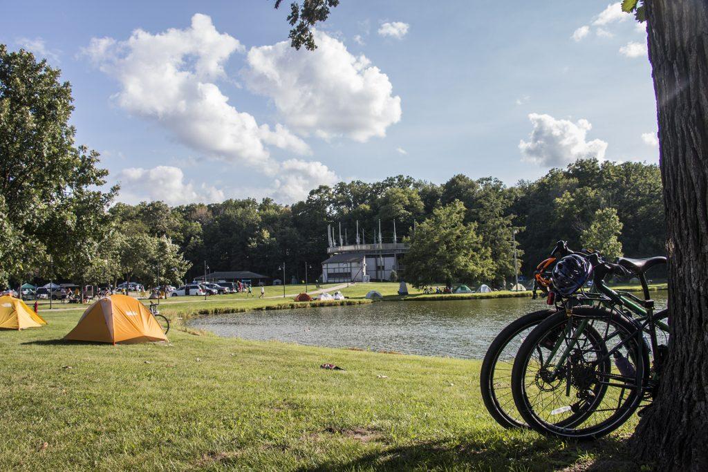 Bikes lean against a tree in Iowa City's City Park during RAGBRAI on July 27, 2018. Riders rode from Sigourney to Iowa City on Day 6 of this year's event. (Katina Zentz/The Daily Iowan)