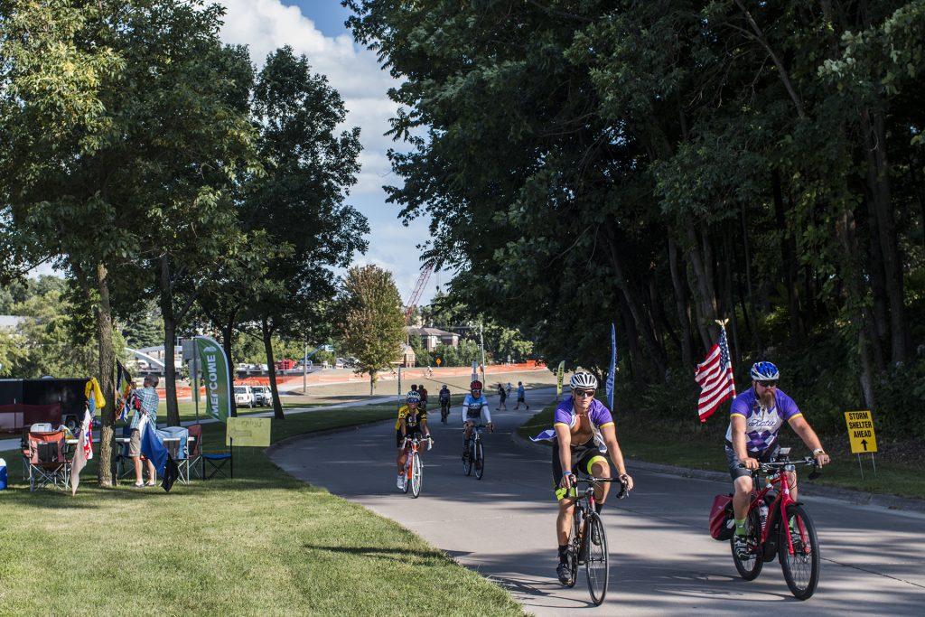 Bikers ride through Iowa City's City park during RAGBRAI on July 27, 2018. Riders rode from Sigourney to Iowa City on Day 6 of this year's event. (Katina Zentz/The Daily Iowan)