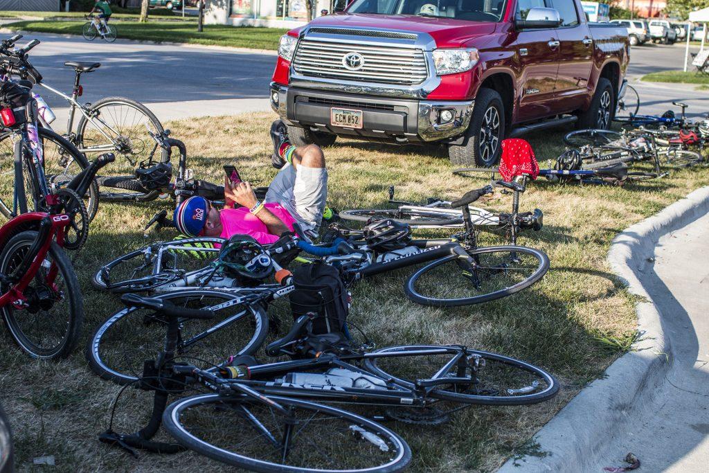 A biker takes a break during RAGBRAI on July 27, 2018. Riders rode from Sigourney to Iowa City on Day 6 of this year's event. (Katina Zentz/The Daily Iowan)