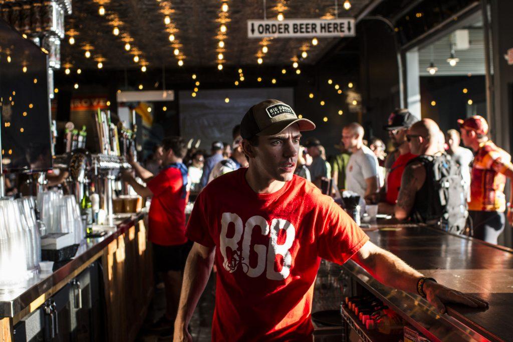 A bartender rushes to fill orders for beer at Big Grove Brewery during RAGBRAI on July 27, 2018. Riders rode from Sigourney to Iowa City on Day 6 of this year's event. (Katina Zentz/The Daily Iowan)