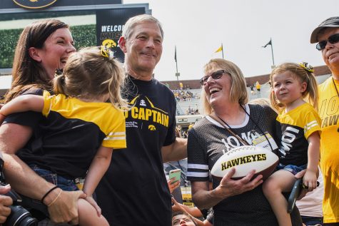 Iowa head coach Kirk Ferentz laughs with the Still family during Iowa Football Kids Day at Kinnick Stadium on Saturday, Aug. 11, 2018.