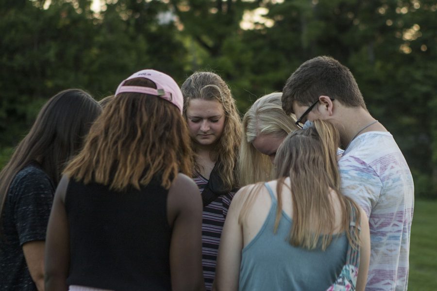 UI senior Haley Steele prays with friends during the vigil in memory of UI student Mollie Tibbetts at Hubbard Park on Wednesday, Aug. 22, 2018. Tibbetts went missing on July 18, in Brooklyn, Iowa. On Tuesday, authorities recovered her body and filed murder charges against 24-year-old Poweshiek County resident Cristhian Bahena Rivera. 