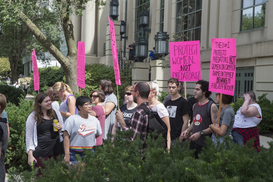 Protestors gather during the Jeffery Nock Protest outside of the Tippie College of Business on Aug. 30, 2018. Students and faculty turned out to protest Professor Jeffery B. Nocks, who is still employed at the university despite charges of taking photographs of women at the Campus Recreation and Wellness Center. (Katie Goodale/ The Daily Iowan).