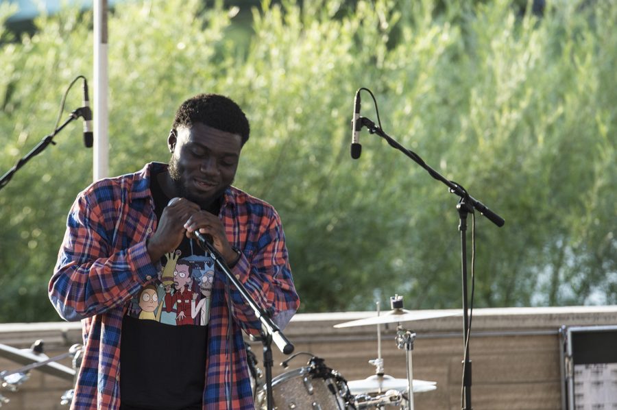 A member of Average addresses the crowd during the Battle of the Bands behind the Iowa Memorial Union  Thursday, Aug. 30, 2018. The groups Average, The Mystic Cats, Nongrata, Scamper, and Dandelion Seminary competed for the grand prize, hosted by Scope Productions.