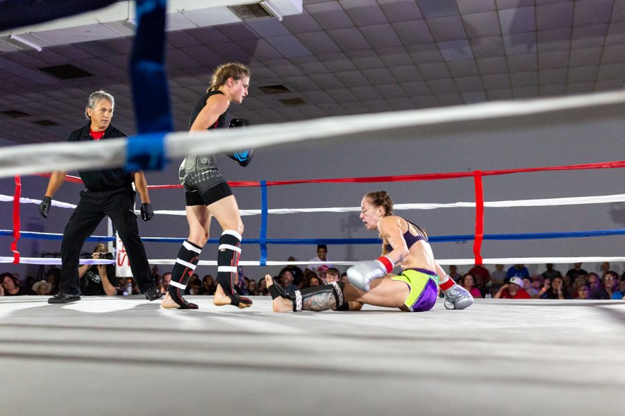 Jacquie Cuddeback knocks down Lillie Helten during a bout at the 115lb weight class at the Midwest Kickboxing Championship at the Teamsters Union Hall in Cedar Rapids, IA on Aug 18, 2018. Cuddeback won the match via unanimous decision.