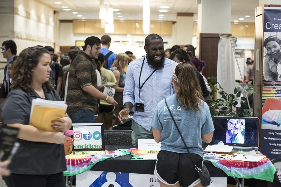 Tony Branch from the Neighborhood Centers of Johnson County speaks to an inquiring student at the student Organization Fair in the IMU on Thursday, Aug. 30, 2018. 