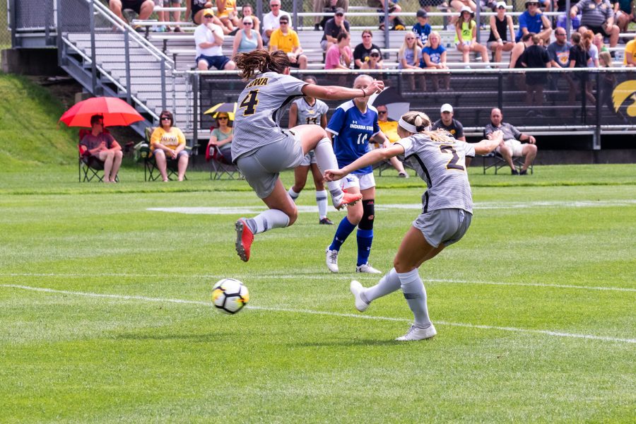 Iowa soccer player Kaleigh Haus jumps over the ball as Hailey Rydberg tries to center it during a game against Indiana State University on Sunday, Aug. 26, 2018. The Hawkeyes defeated the Sycamores 1-0. 