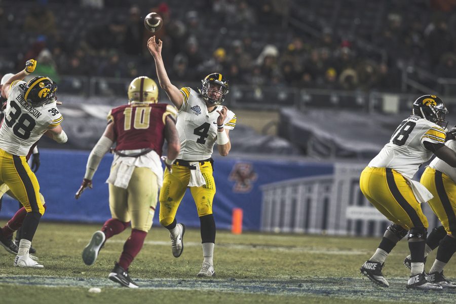 Iowa quarterback Nate Stanley (4) throws a pass to wide receiver Nick Easley (84) during the New Era Pinstripe Bowl at Yankee Stadium in New York on Wednesday, Dec. 27. The Hawkeyes went on to win 27-20.