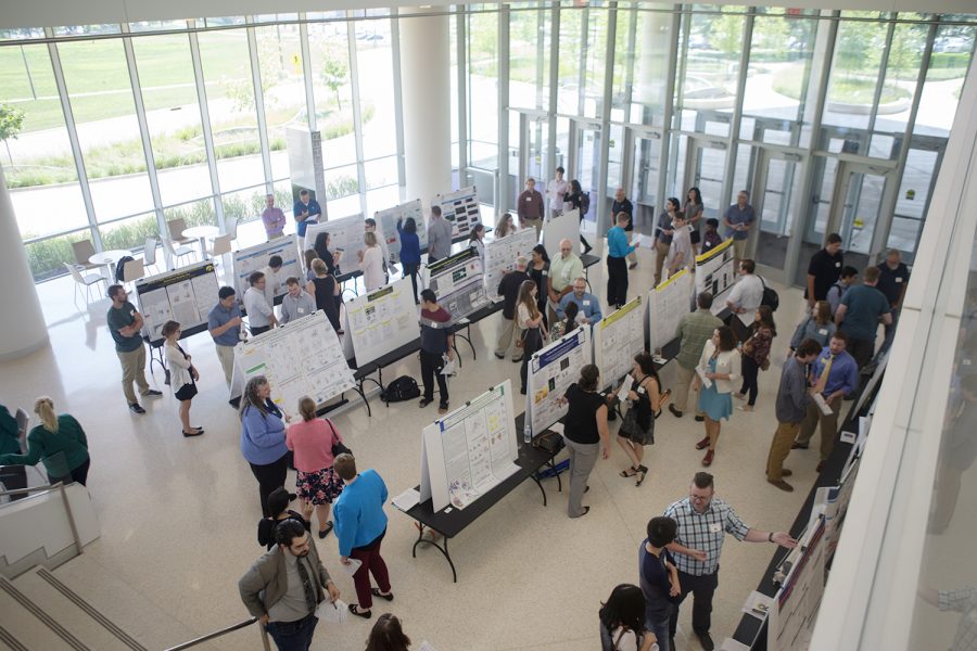 Attendees wander the aisles of the poster presentation during the Biochemistry 70th anniversary on Aug. 25, 2018 in Hancher Auditorium located in Iowa City. The anniversary offered varying speakers, poster sessions, an awards ceremony, and finishing with dinner. 