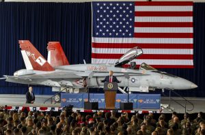With a F/A-18 Hornet behind him, President Donald Trump speaks to Marines at Marine Corps Air Station Miramar in San Diego, Calif. on March 13, 2018. (Hayne Palmour IV/San Diego Union-Tribune/TNS)