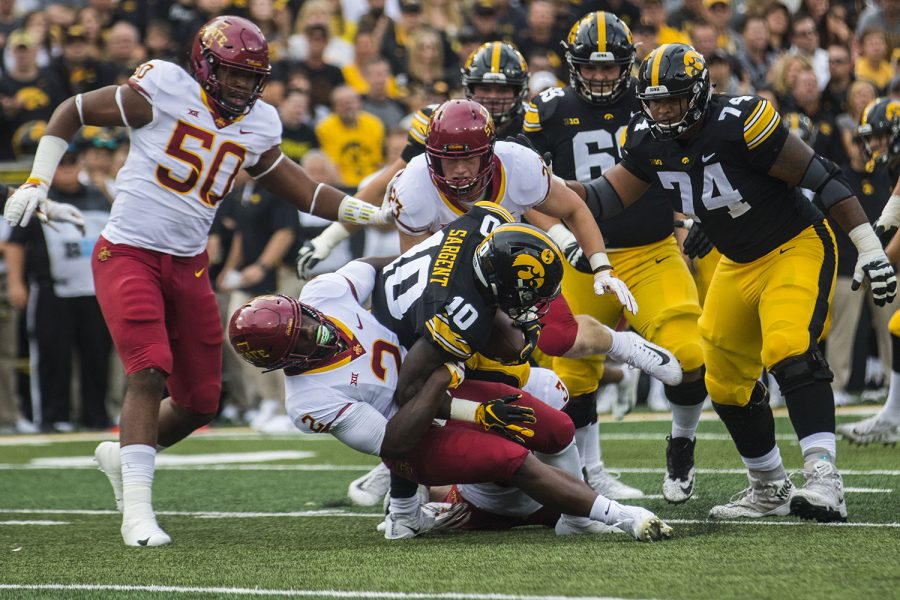 Iowa's Mekhi Sargent gets tackled by Iowa State's Willie Harvey during the Iowa/Iowa State football game at Kinnick Stadium on Saturday, Sept. 8, 2018. The Hawkeyes defeated the Cyclones, 13-3. 