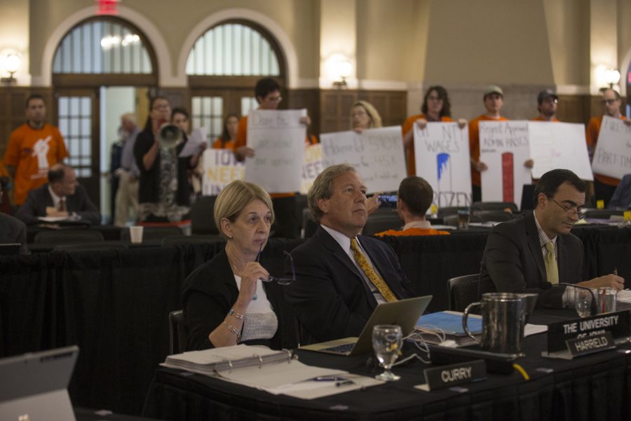 Interim Provost Sue Curry (left), University of Iowa President Bruce Herreld (center), and Senior Vice President of Finance and Operation Rob Lehnertz (right) sit in silence as protesters interrupt the Board of Regents meeting on Sept. 13, 2018 in the IMU Main Lounge. 