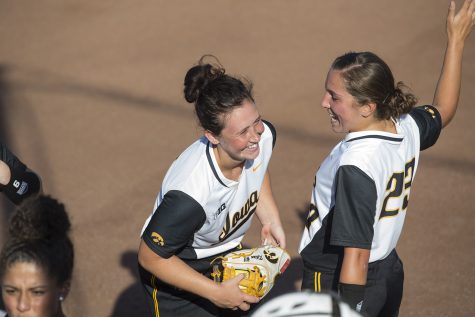 Senior Mallory Kilian and junior Alex Rath joke around during the Iowa v Kirkwood softball game at the Pearl Softball Complex in Coralville on Sept. 14, 2018. The Hawkeyes defeated the Kirkwood Eagles 10-6. 