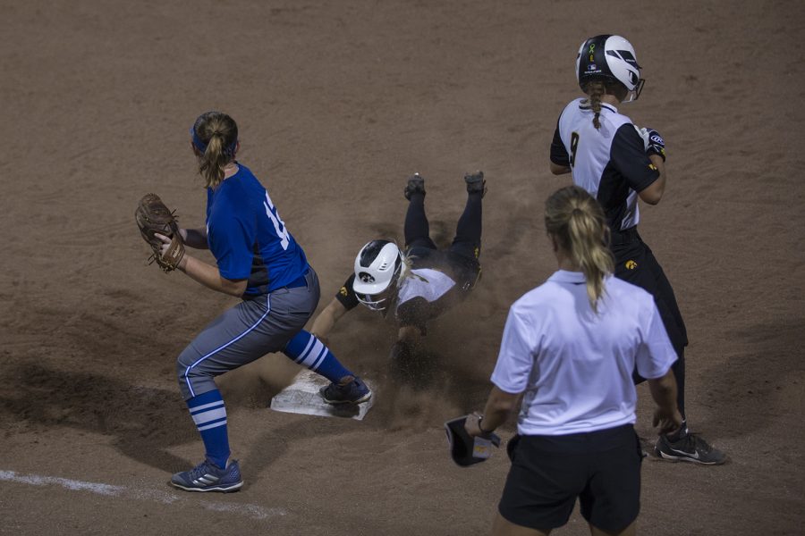 Junior Havyn Ketcham, outfielder, slides into first during the Iowa v Kirkwood softball game at the Pearl Softball Complex in Coralville on Sept 14, 2018. The Hawkeyes defeated the Kirkwood Eagles 10-6. 