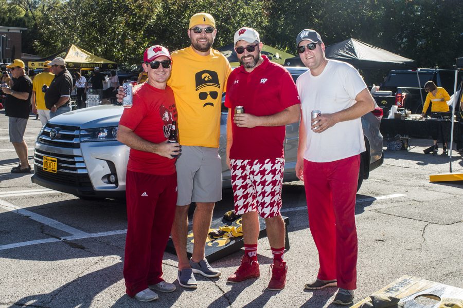 Hawkeye and Badger fans pose for a portrait outside of Kinnick Stadium on Saturday, September 22, 2018. Both Hawkeye and Badger fans tailgated throughout Iowa City prior to the Iowa vs. Wisconsin football game. (Katina Zentz/The Daily Iowan)