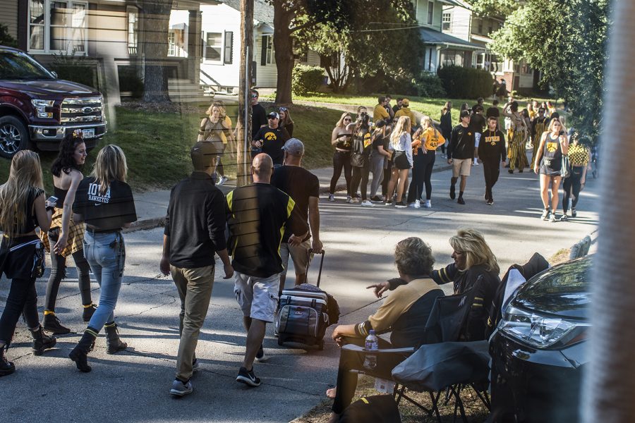 Fans walk toward Kinnick Stadium on Saturday, September 22, 2018. Both Hawkeye and Badger fans tailgated throughout Iowa City prior to the Iowa vs. Wisconsin  football game. (Katina Zentz/The Daily Iowan)