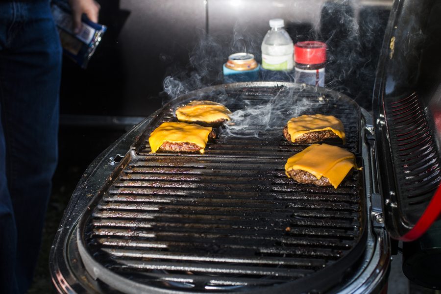 Hamburgers cook on Saturday, September 22, 2018. Both Hawkeye and Badger fans tailgated throughout Iowa City prior to the Iowa vs. Wisconsin  football game. (Katina Zentz/The Daily Iowan)