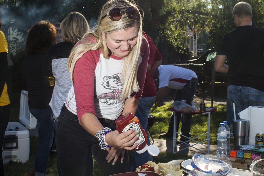 A fan pours ketchup onto a hotdog on Saturday, September 22, 2018. Both Hawkeye and Badger fans tailgated throughout Iowa City prior to the Iowa vs. Wisconsin  football game. (Katina Zentz/The Daily Iowan)