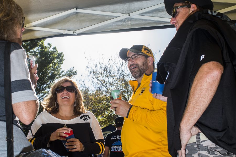 Fans laugh while at a tailgate on Saturday, September 22, 2018. Both Hawkeye and Badger fans tailgated throughout Iowa City prior to the Iowa vs. Wisconsin  football game. (Katina Zentz/The Daily Iowan)