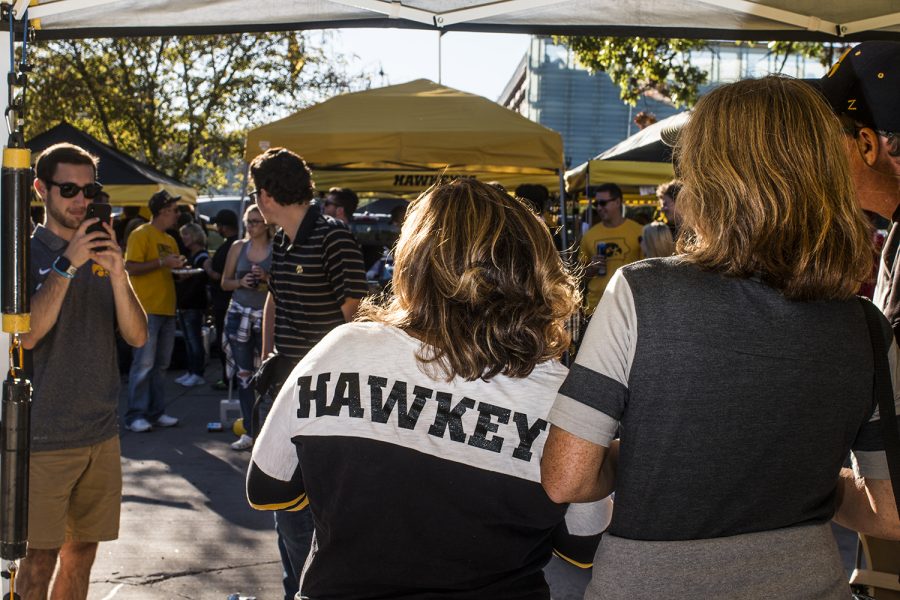 Fans pose for a photo on Saturday, September 22, 2018. Both Hawkeye and Badger fans tailgated throughout Iowa City prior to the Iowa vs. Wisconsin  football game. (Katina Zentz/The Daily Iowan)