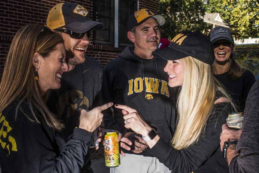 Iowa alumni laugh outside of Kinnick Stadium on Saturday, September 22, 2018. Both Hawkeye and Badger fans tailgated throughout Iowa City prior to the Iowa vs. Wisconsin  football game. (Katina Zentz/The Daily Iowan)