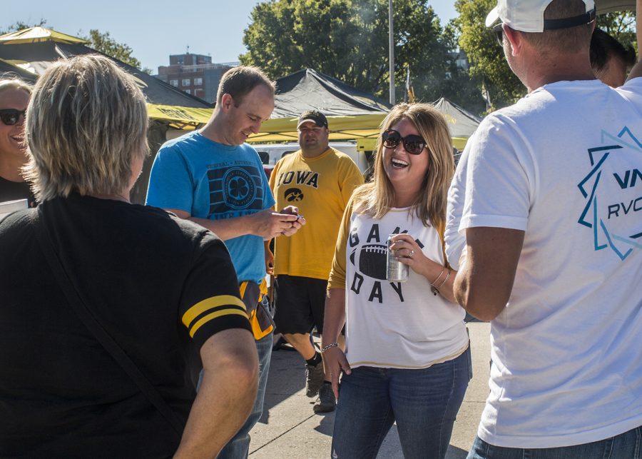 Fans laugh while tailgating on Saturday, September 22, 2018. Both Hawkeye and Badger fans tailgated throughout Iowa City prior to the Iowa vs. Wisconsin  football game. (Katina Zentz/The Daily Iowan)