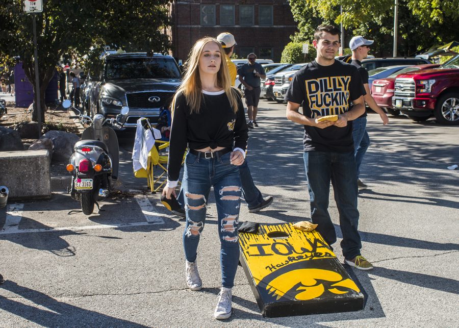 Fans play a beanbag game on Saturday, September 22, 2018. Both Hawkeye and Badger fans tailgated throughout Iowa City prior to the Iowa vs. Wisconsin  football game. (Katina Zentz/The Daily Iowan)