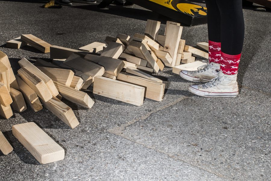 UI Junior Alexandra Ohn stands by fallen Jenga pieces on Saturday, September 22, 2018. Both Hawkeye and Badger fans tailgated throughout Iowa City prior to the Iowa vs. Wisconsin  football game. (Katina Zentz/The Daily Iowan)