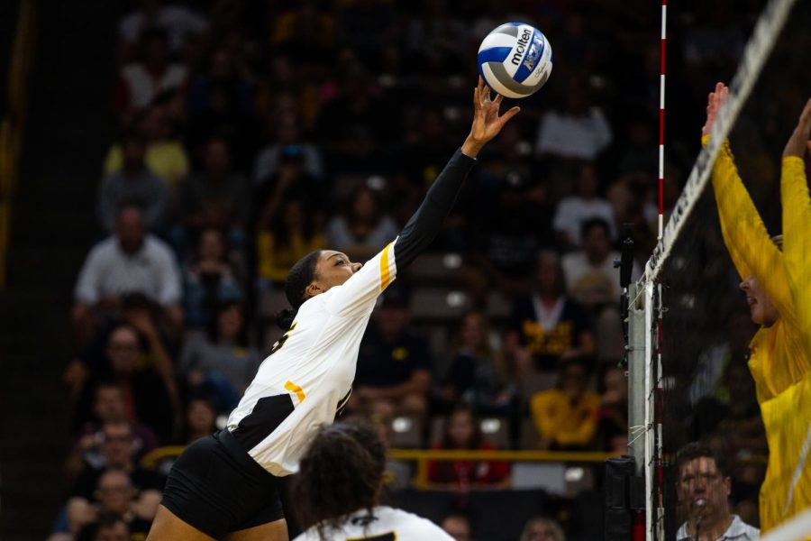 Taylor Louis tips the ball over the net during Iowas match against Michigan at Carver-Hawkeye Arena on September 23, 2018. The Hawkeyes were defeated 3-1. (Megan Nagorzanski/The Daily Iowan)