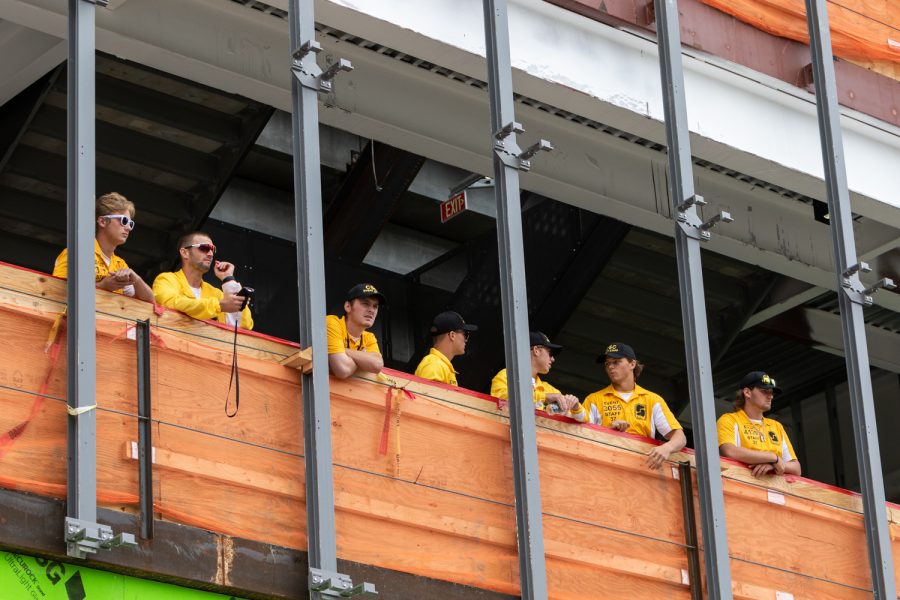 Stadium staff watches the growing crowd from a construction area in the north end zone of Kinnick Stadium before a football game against Iowa State University on Saturday, Sep. 8, 2018.